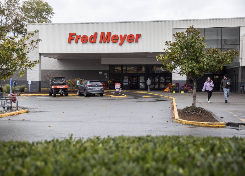 People walk in and out of Fred Meyer along Highway 99 and Casino Road on Tuesday, Oct. 24, 2023 in Everett, Washington. (Olivia Vanni / The Herald)

