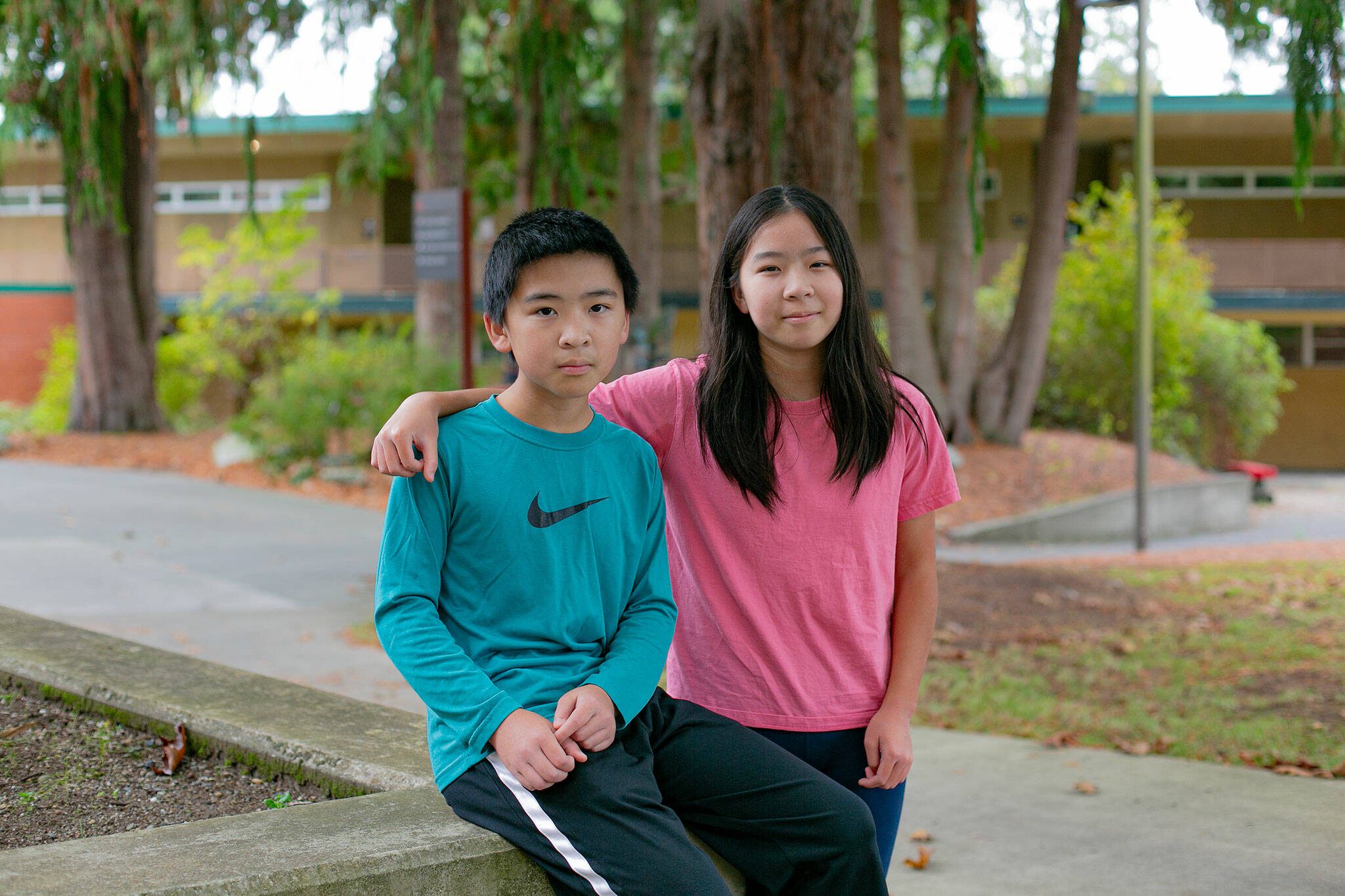 Siblings Qingyun Li, left, and Ruoyun Li, 12 and 13, respectively, are together on campus at Everett Community College. The two are taking three courses for credit at the community college and also a full load of middle school classes. (Ryan Berry / The Herald)