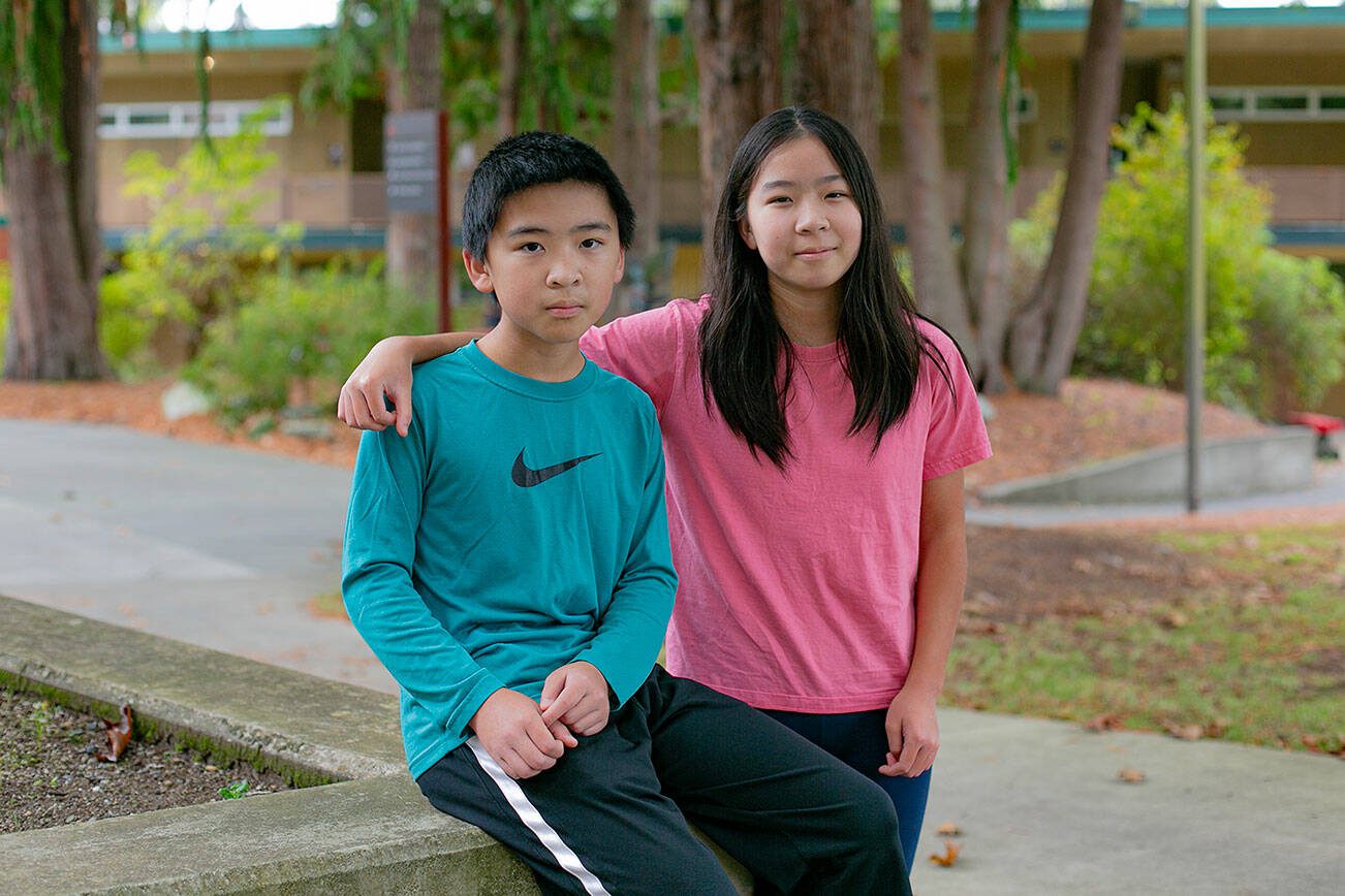 Siblings Qingyun, left, and Ruoyun Li, 12 and 13, respectively, are together on campus at Everett Community College on Thursday, Oct. 19, 2023, in Everett, Washington. The two are taking a full course load at the community college this semester. (Ryan Berry / The Herald)