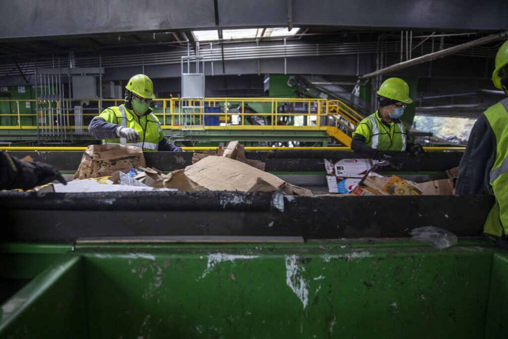 Items are sorted for recycling inside the Waste Management Cascade Recycling Center in Woodinville, Washington on Wednesday, Nov. 1, 2023. (Annie Barker / The Herald)
