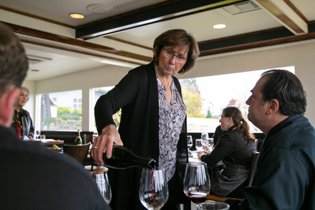 Diane Symms, founder and co-owner of the Lombardi Group, pours wine during a tasting with staff at Hook & Cleaver on Wednesday, Nov. 1, 2023, in Mukilteo, Washington. (Ryan Berry / The Herald)
