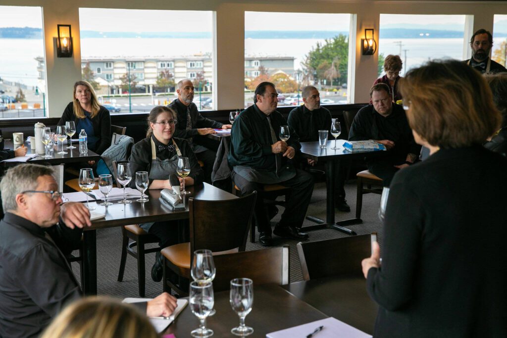 Front of house staff join together for a wine tasting at Hook & Cleaver on Wednesday, Nov. 1, 2023, in Mukilteo, Washington. (Ryan Berry / The Herald)

