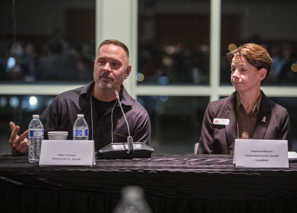 Snohomish County Sheriff candidates Adam Fortney Susanna Johnson during an Everett Council of Neighborhoods forum on Monday, Oct. 16, 2023 in Everett, Washington. (Olivia Vanni / The Herald)
