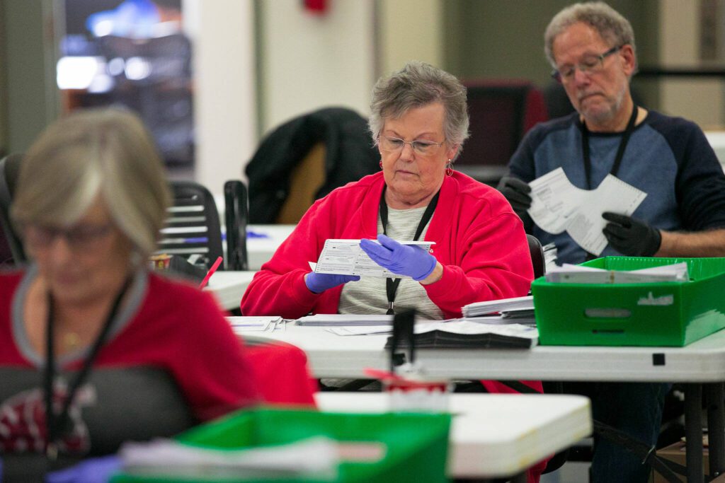 Election workers check to ensure ballots are filled out properly before being counted at the Snohomish County Auditor’s office on Friday, Nov. 3, 2023, in downtown Everett, Washington. (Ryan Berry / The Herald)
