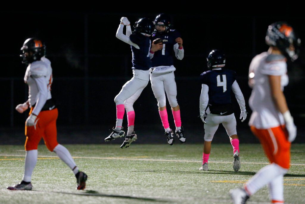 Arlington celebrates Leyton Martin’s long touchdown run against Monroe on Oct. 27 in Arlington. (Ryan Berry / The Herald)
