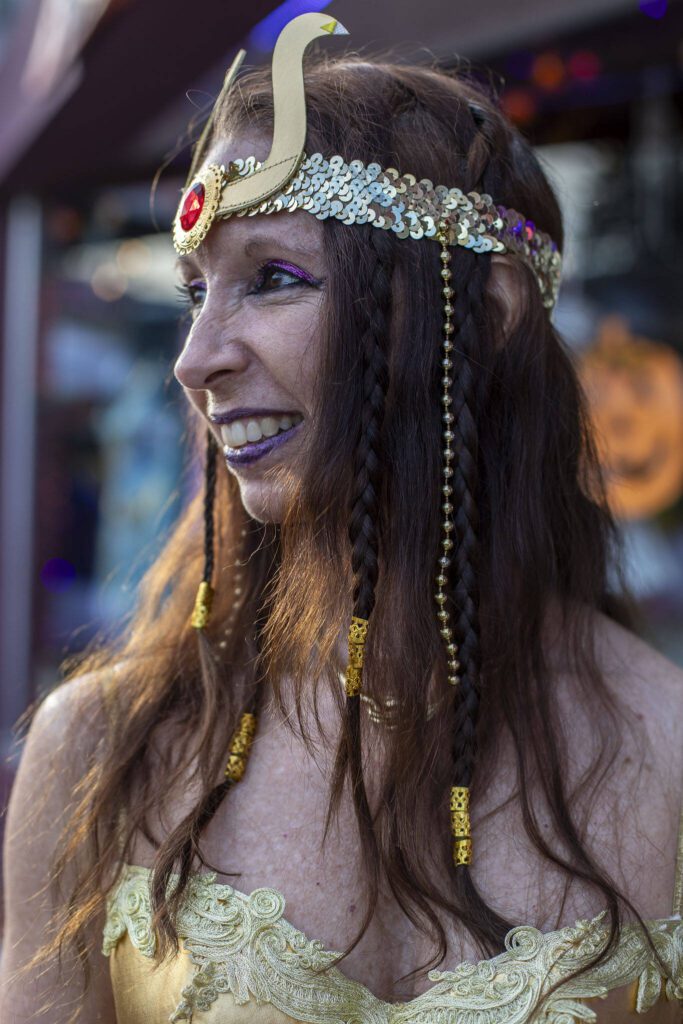 Robin Roth poses for a photo during the Downtown Trick or Treat event in Monroe, Washington on Tuesday, Oct. 31, 2023. Children, teens and families walked Main Street to collect candy from local businesses. Dogs sported costumes as well and decorations adorned buildings. (Annie Barker / The Herald)
