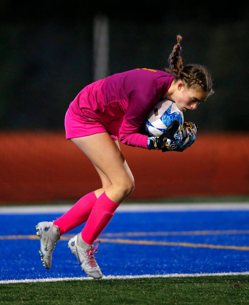 Everett goalie Emerson Hammer collects a shot during a district playoff matchup against Oak Harbor on Thursday, Nov. 2, 2023, at Shoreline Stadium in Shoreline, Washington. (Ryan Berry / The Herald)
