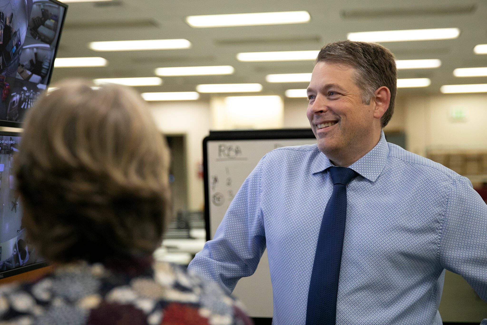 Garth Fell, incumbent Snohomish County Auditor, cracks a smile as the first results of the 2023 election appear on a screen at the elections office in Administrative Building West on Tuesday, Nov. 7, 2023, in downtown Everett, Washington. Fell led by nearly 20% after initial results. (Ryan Berry / The Herald)