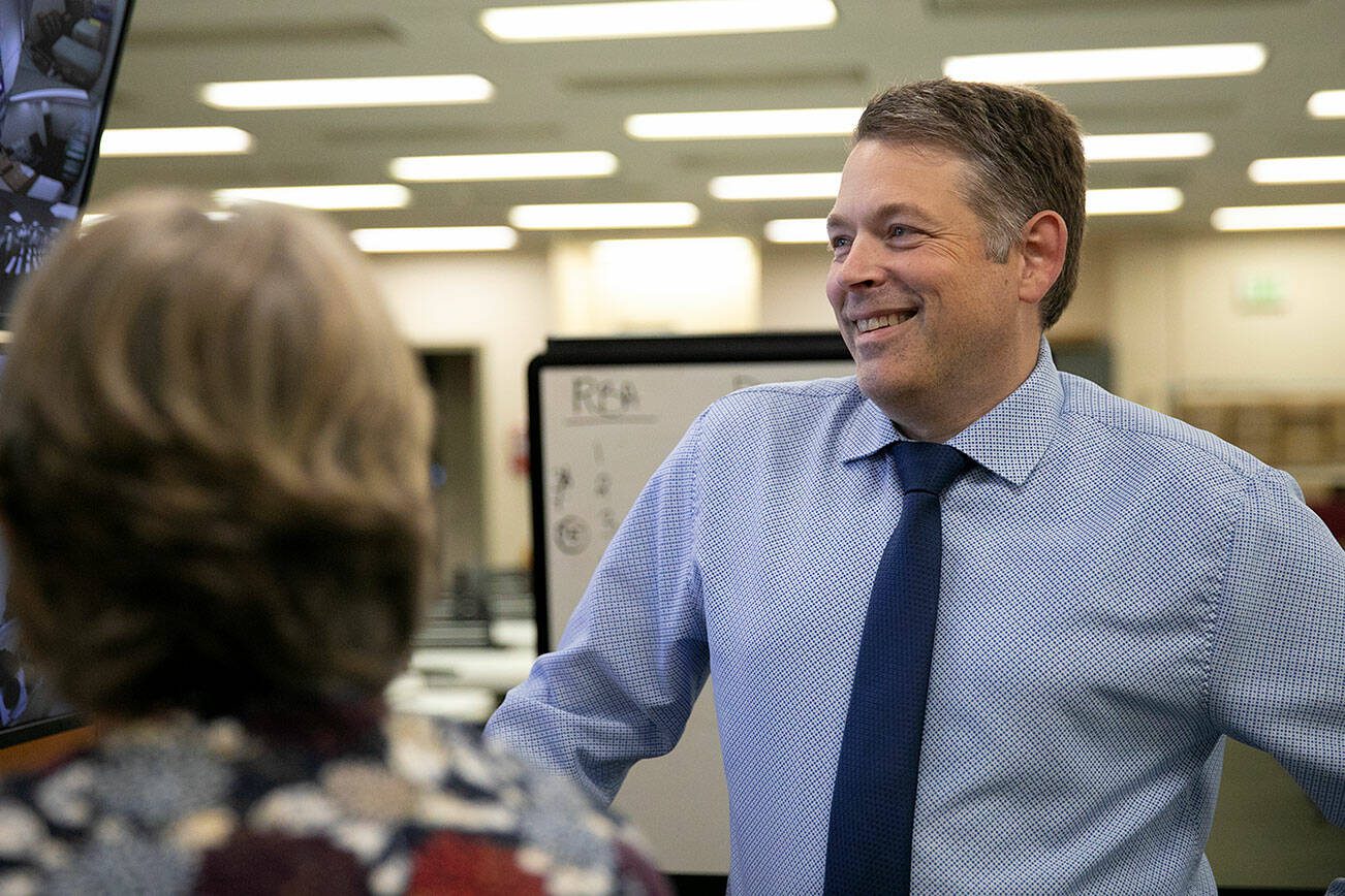 Garth Fell, incumbent Snohomish County Auditor, cracks a smile as the first results of the 2023 election appear on a screen at the elections office in Administrative Building West on Tuesday, Nov. 7, 2023, in downtown Everett, Washington. Fell led by nearly 20% after initial results. (Ryan Berry / The Herald)
