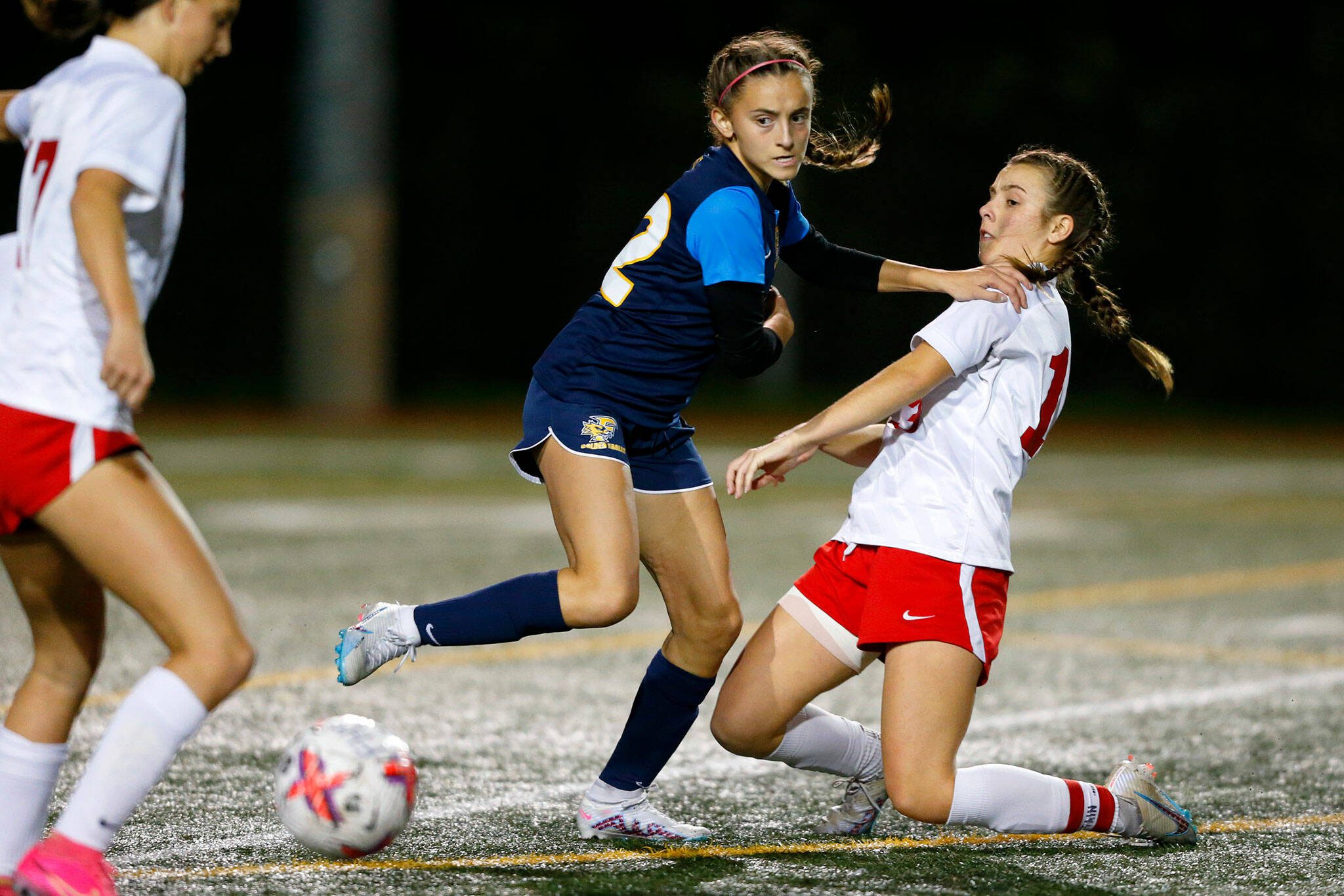 Mountlake Terrace’s Natalie Cardin gets pushed to the ground while trying to get to the ball during a district playoff matchup against Ferndale on Thursday, Nov. 2, 2023, at Shoreline Stadium in Shoreline, Washington. (Ryan Berry / The Herald)