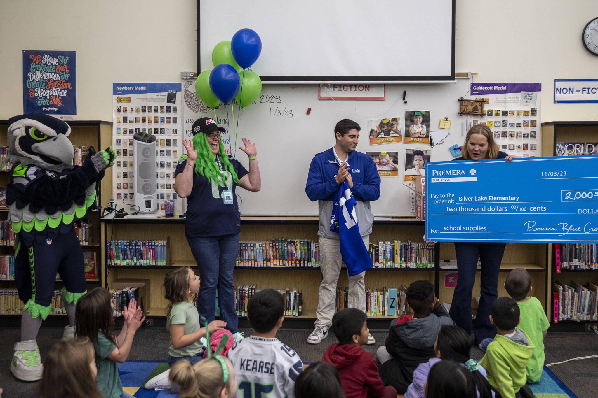 Crystal Moore, second from left, and her class are surprised with a $2,000 cash donation through the Primera Heroes in the Classroom program at Silver Lake Elementary in Everett, Washington on Friday, Nov. 3, 2023. (Annie Barker / The Herald)