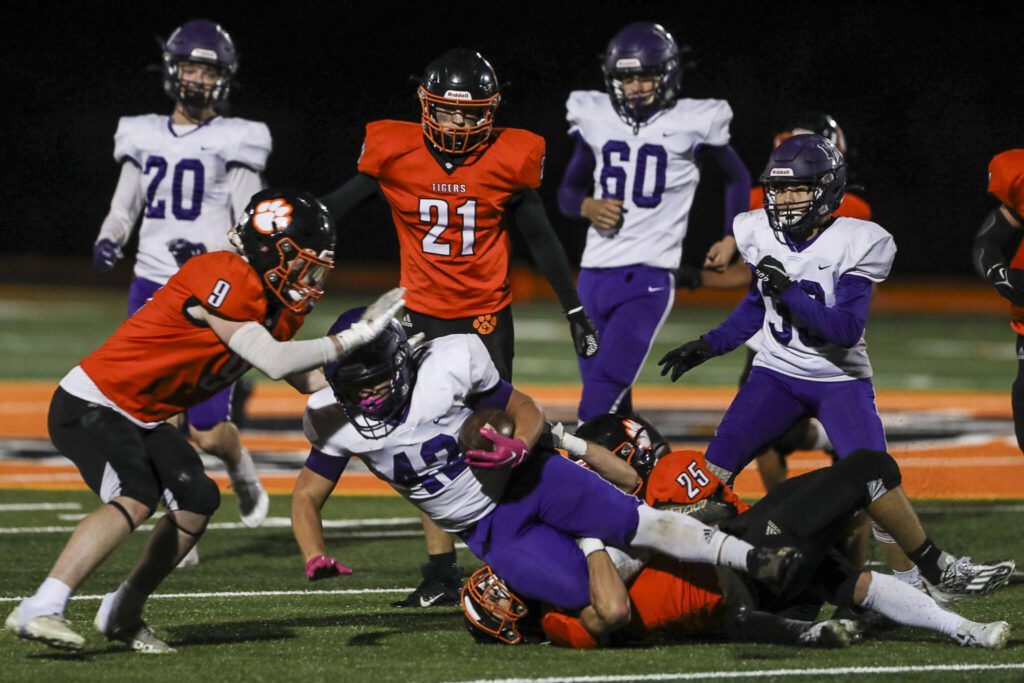 Nooksack Valley’s Aadan Huante (42) is tackled during a game between Granite Falls and Nooksack Valley at Granite Falls High School in Granite Falls, Washington on Friday, Nov. 3, 2023. Nooksack Valley won, 56-0. (Annie Barker / The Herald)
