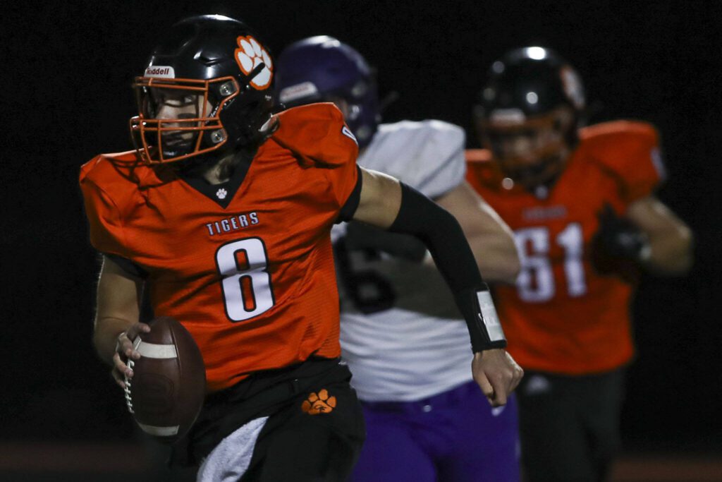 Granite Falls’ Kaden LaPlaunt (8) runs with the ball during a game between Granite Falls and Nooksack Valley at Granite Falls High School in Granite Falls, Washington on Friday, Nov. 3, 2023. (Annie Barker / The Herald)
