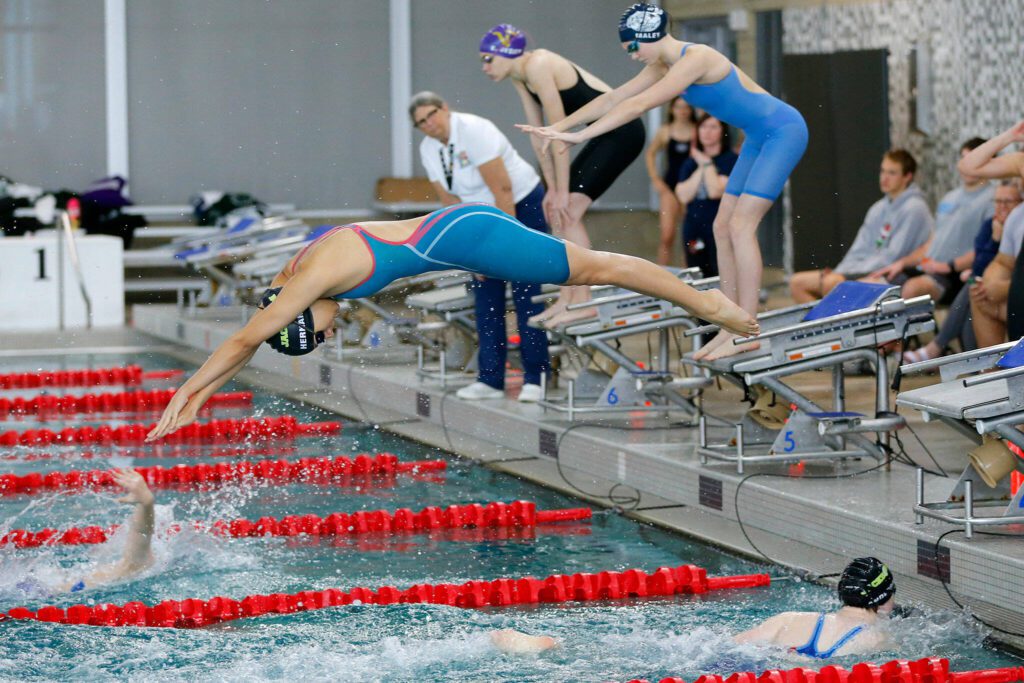 Jackson senior Celina Hernandez-Murillo dives in during the 200 yard freestyle relay at the Wesco 4A District 1 Girls Swim and Dive Finals on Saturday, Nov. 4, 2023, at the Snohomish Aquatic Center in Snohomish, Washington. (Ryan Berry / The Herald)
