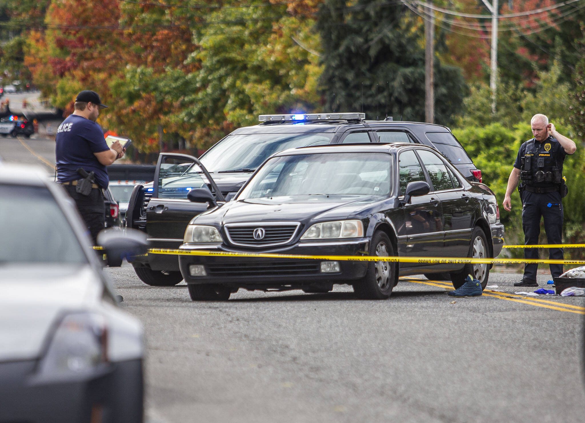 Police survey a scene where a victim was found in a vehicle with bullet holes in the passenger side of the windshield along East Casino Road on Friday, Oct. 13, 2023 in Everett, Washington. (Olivia Vanni / The Herald)