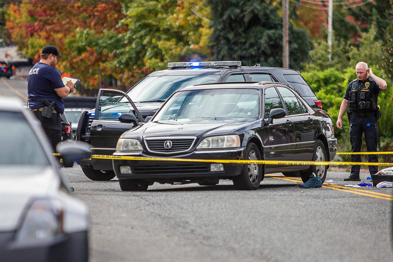 Police survey a scene where a victim was found in a vehicle with bullet holes in the passenger side of the windshield along East Casino Road on Friday, Oct. 13, 2023 in Everett, Washington. (Olivia Vanni / The Herald)