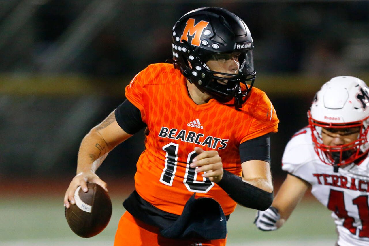 Monroe’s Blake Springer rolls out of the pocket before firing downfield against Mountlake Terrace on Sept. 29 in Monroe. Springer leads the area with 2,530 passing yards. (Ryan Berry / The Herald)