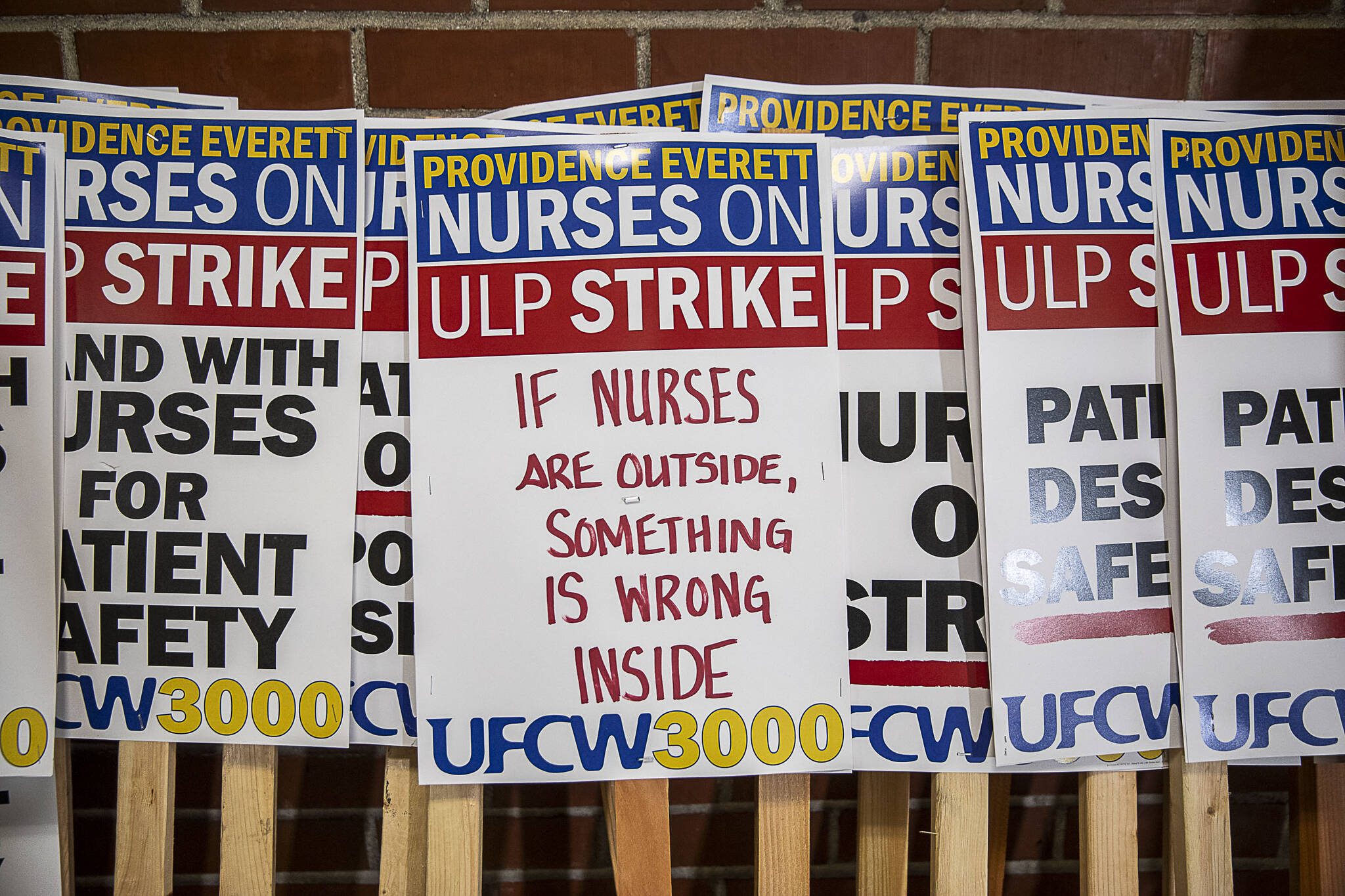 Strike signs are displayed during a press confrence for the Providence nurses who gave a 10-day strike notice two days ago at the Everett Labor Temple in Everett, Washington on Monday, Nov. 6, 2023. (Annie Barker / The Herald)