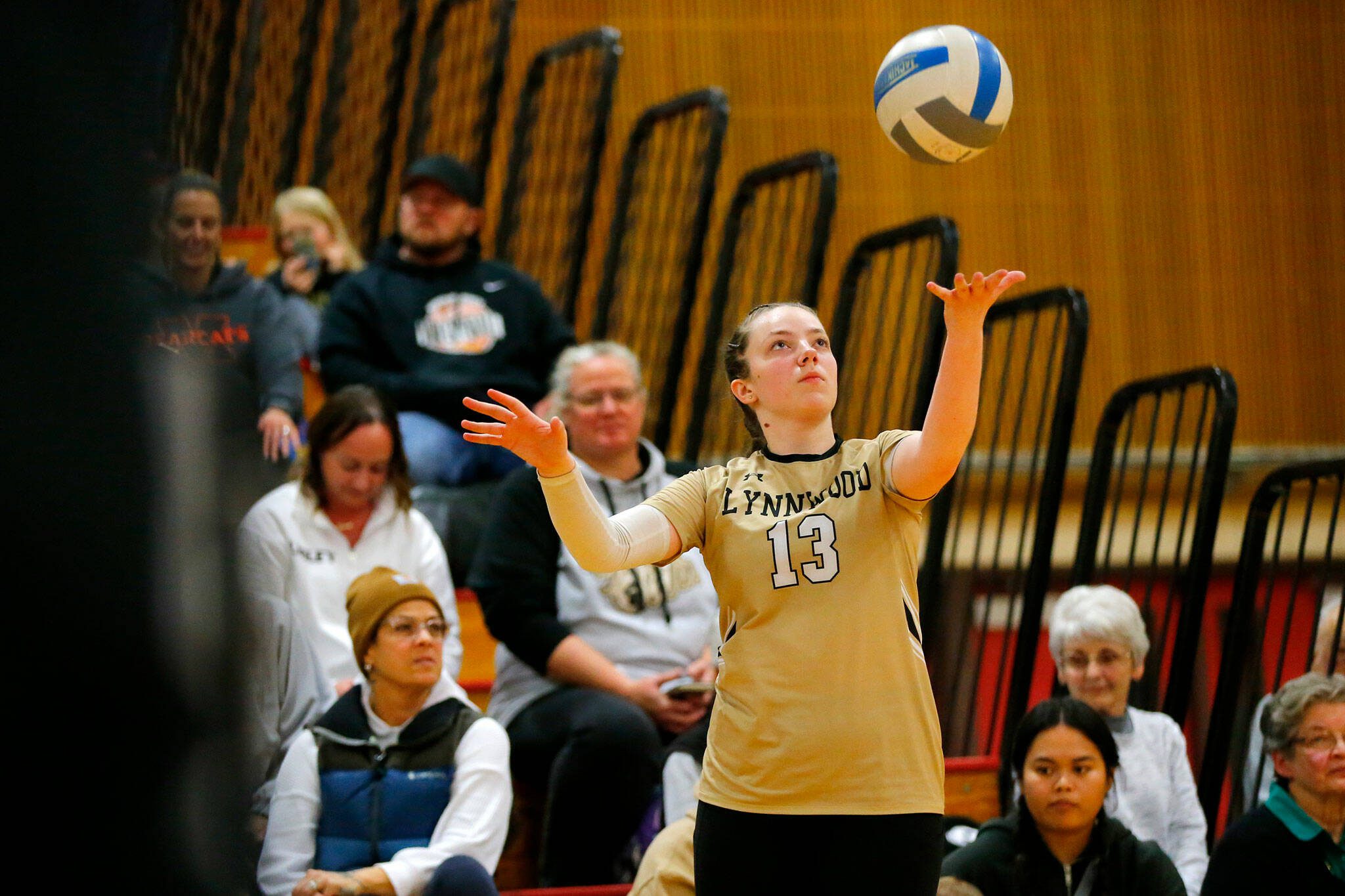 Lynnwood senior Charlie Thomas begins her serve during a Class 3A District 1 volleyball match against Shorecrest on Thursday at Marysville Pilchuck High School in Marysville. (Ryan Berry / The Herald)