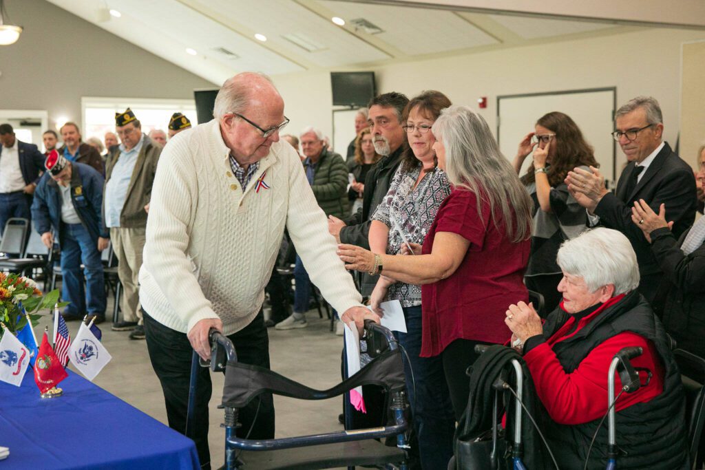 U.S. Army veteran George Michael Taylor walks by the family of George Michael “Mike” Taylor after sharing his experience of the War in Vietnam during a Veterans Day program at the Snohomish Senior Center on Friday, Nov. 10, 2023, in Snohomish, Washington. (Ryan Berry / The Herald)
