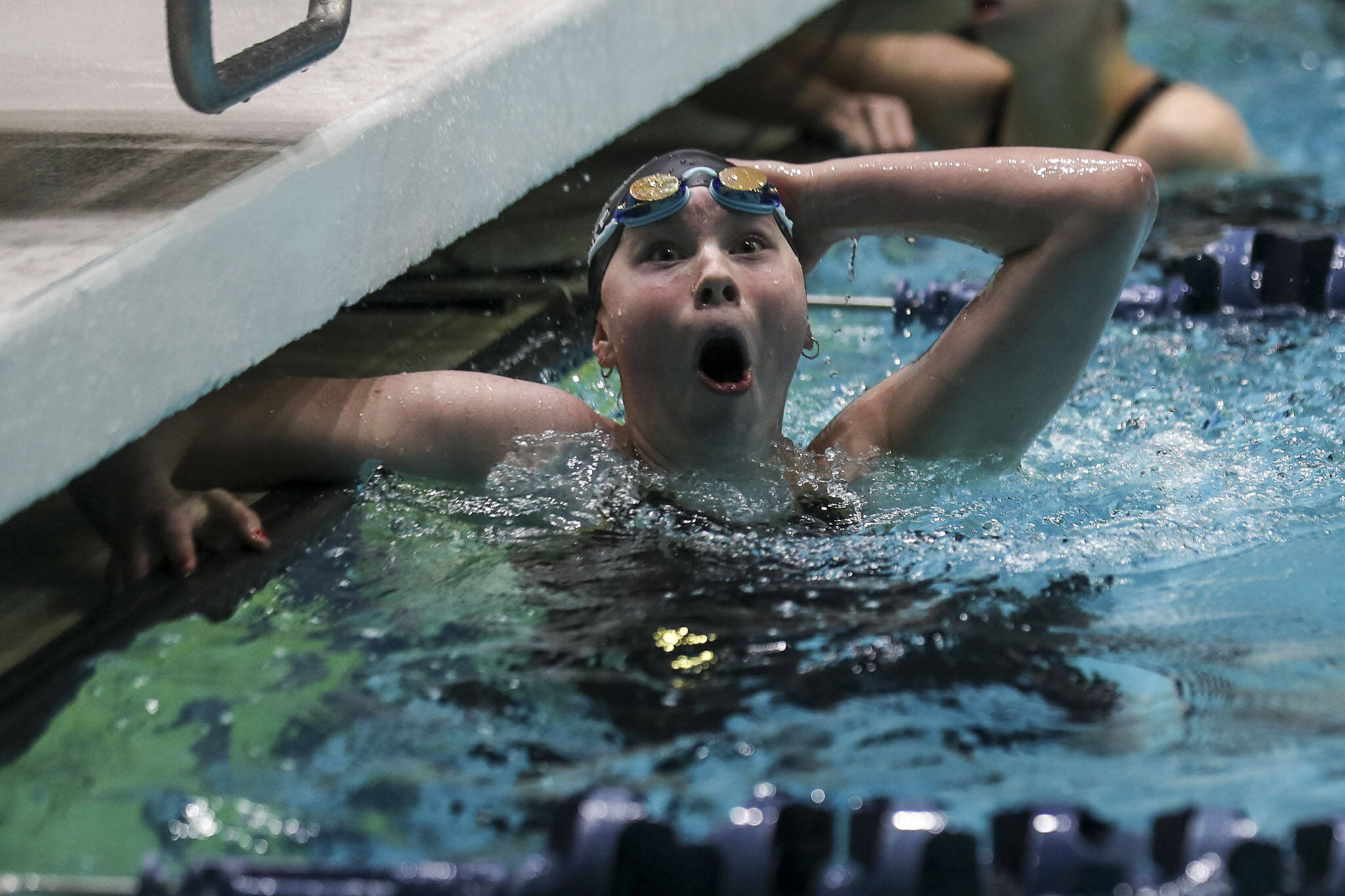 Snohomish’s Mary Clarke reacts to winning the Class 3A 100-yard freestyle title at the girls state swim and dive championships Saturday at King County Aquatic Center in Federal Way. (Annie Barker / The Herald)