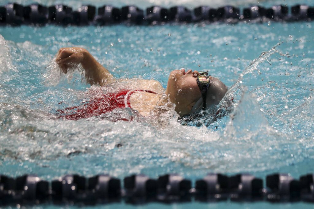 Stanwood’s Miya Watanabe performs in the 50-yard backstroke adaptive race during the 3A girls state swim and dive championships at King County Aquatic Center in Federal Way, Washington on Saturday, Nov. 11, 2023. (Annie Barker / The Herald)
