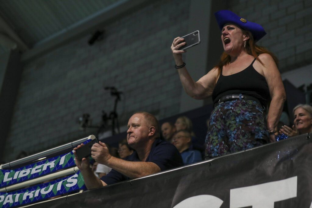 Fans cheer during the 3A girls state swim and dive championships at King County Aquatic Center in Federal Way, Washington on Saturday, Nov. 11, 2023. (Annie Barker / The Herald)
