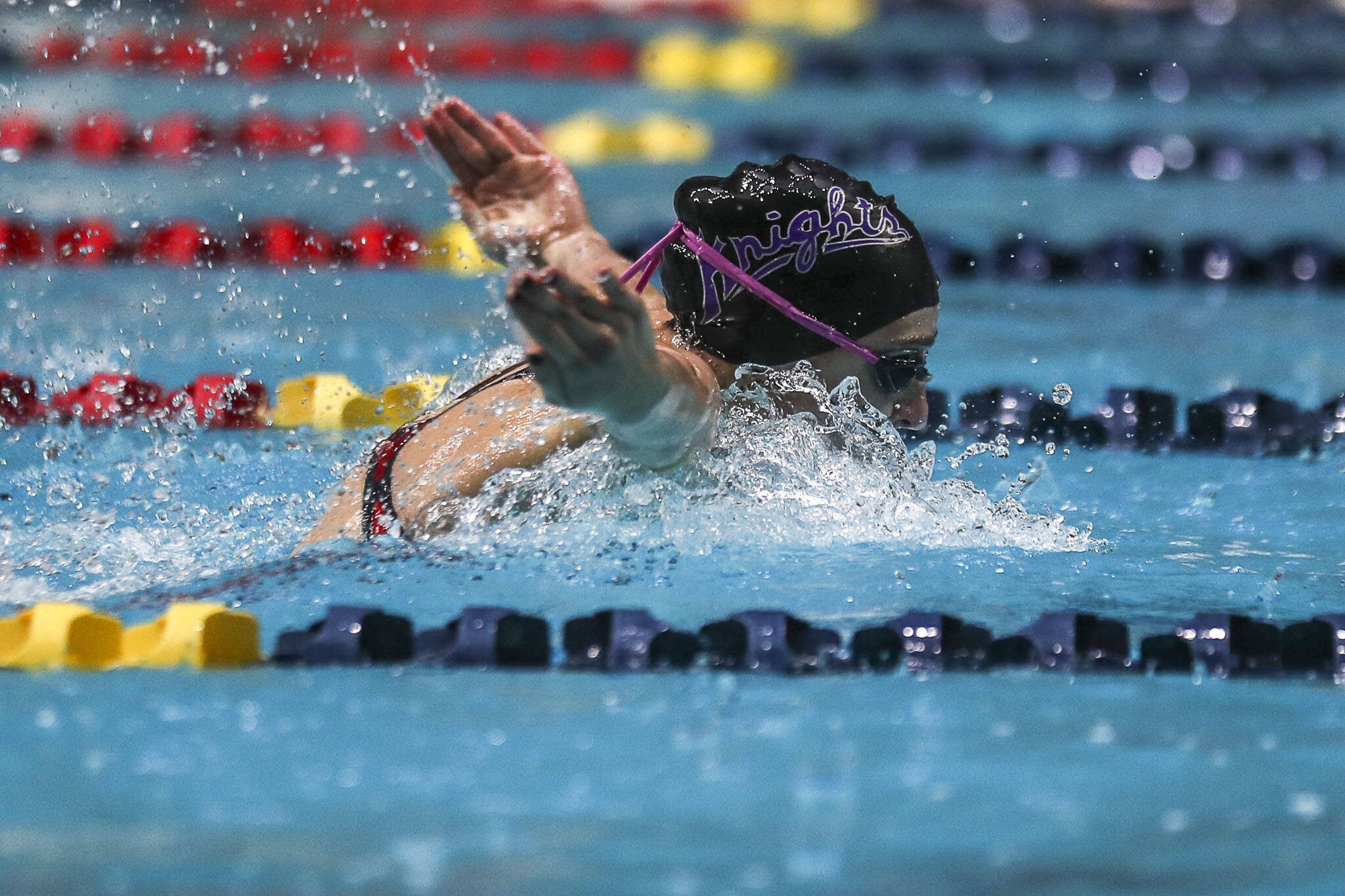 Kamiak’s Claire Smith swims in the 100-yard butterfly during the Class 4A girls state swim and dive championships Saturday at King County Aquatic Center in Federal Way. (Annie Barker / The Herald)