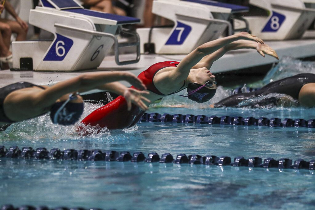 Kamiak’s Claire Smith swims in heat two of the 100 yard backstroke during the 4A girls state swim and dive championships at King County Aquatic Center in Federal Way, Washington on Saturday, Nov. 11, 2023. (Annie Barker / The Herald)
