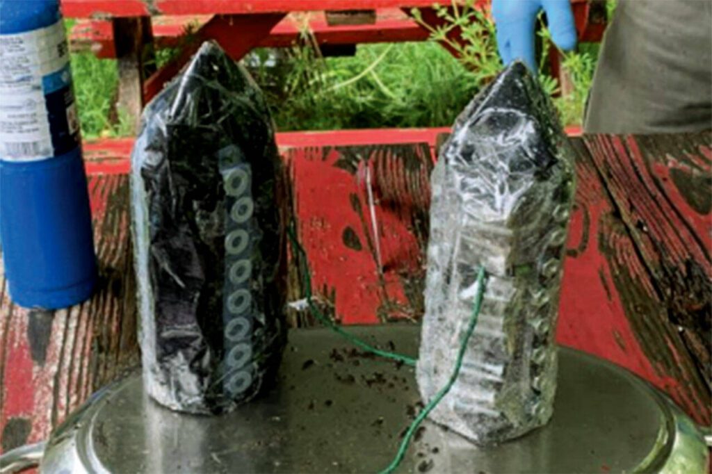 This photo shows plastic bottles filled with explosive powder and wrapped with metal screws that were described as “shrapnel bombs.” (U.S. Attorney’s Office)
