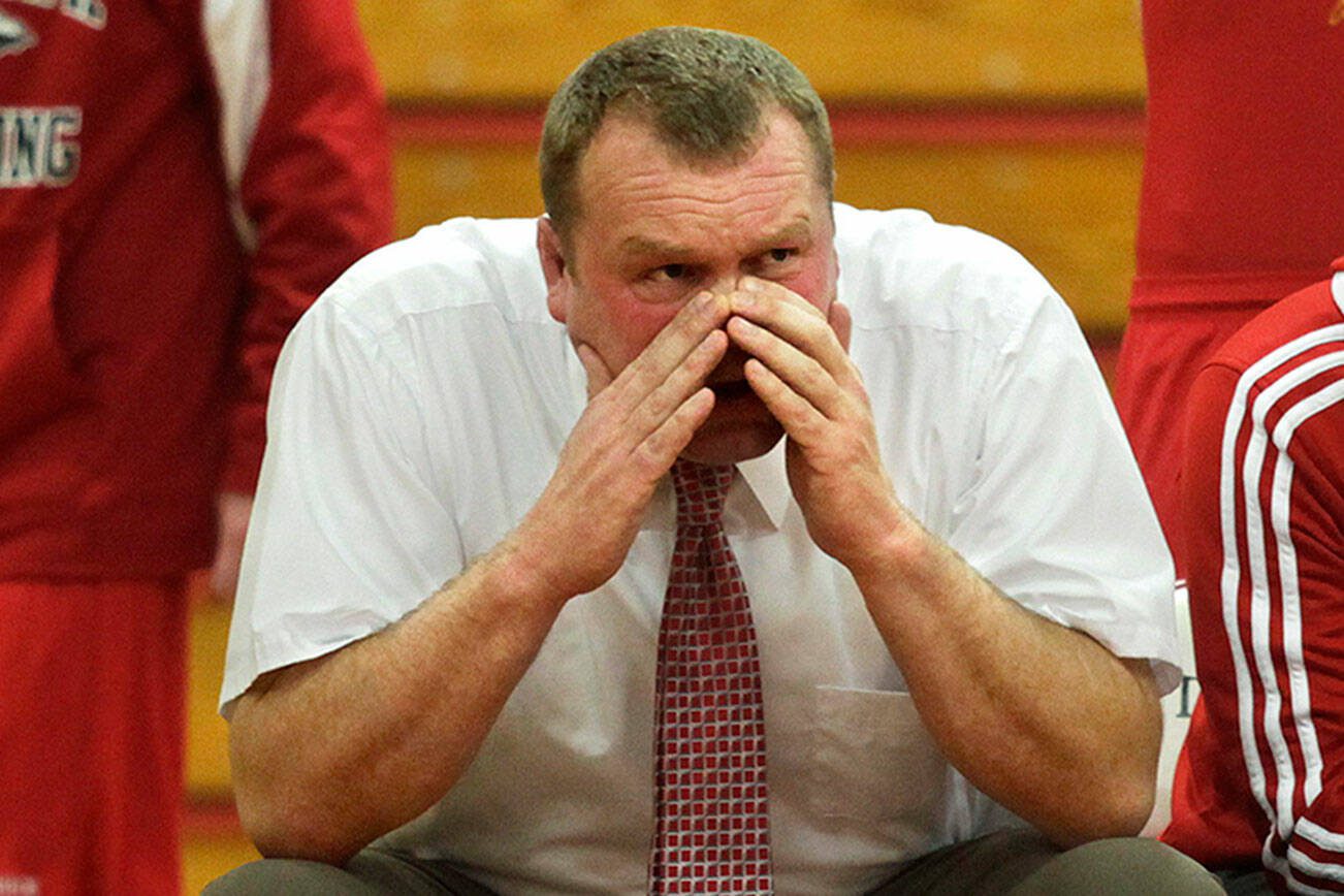 Annie Mulligan / For The Herald
Marysville-Pilchuck head wrestling coach Craig Iversen, center, cheers on his team during a nonconference meet against Arlington High School on Dec. 12.
Photo taken 121212