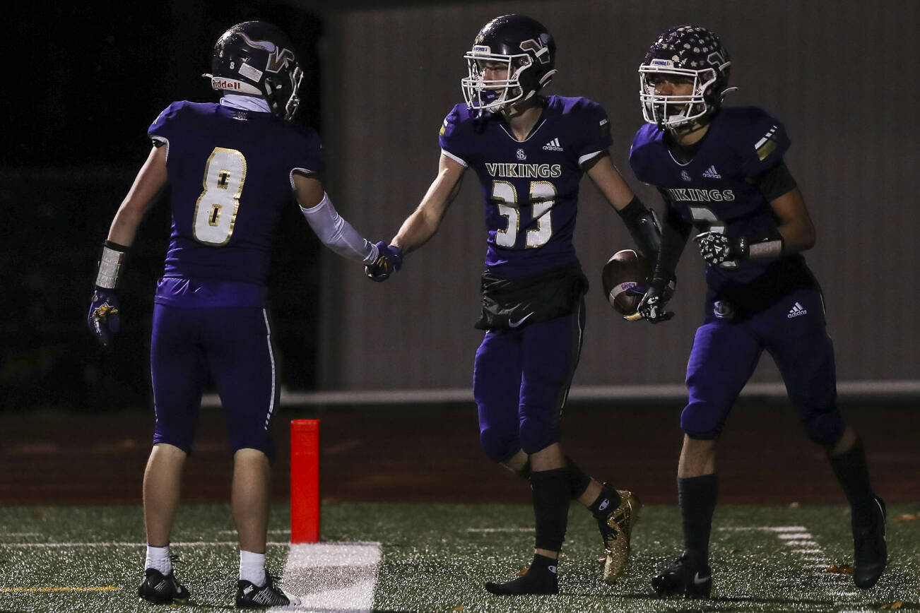Lake Stevens players celebrate a touchdown during a football game between Lake Stevens and Woodinville at Lake Stevens High School in Lake Stevens, Washington on Friday, Nov. 10, 2023. Lake Stevens won, 41-0. (Annie Barker / The Herald)