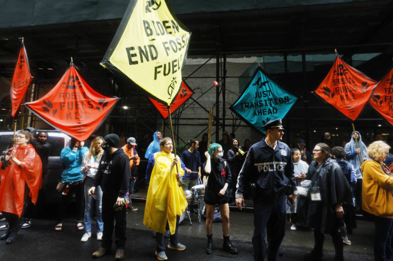Climate activists protest outside the Federal Reserve Bank of New York to call for an end to the use of fossil fuels, Sept. 18, in New York. (Jason DeCrow / Associated Press)