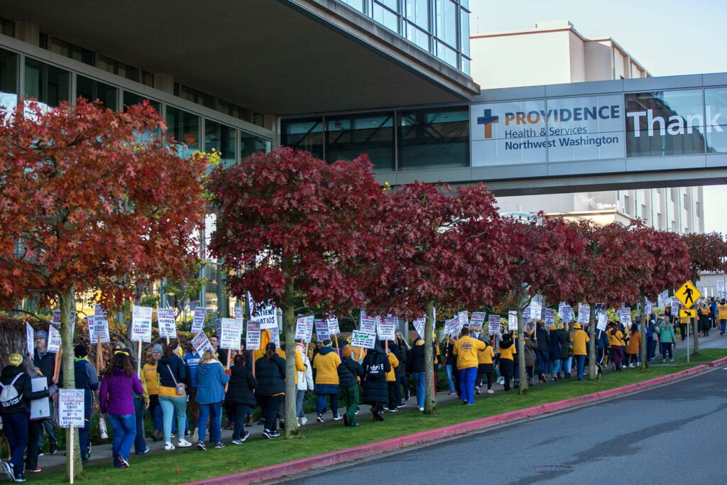 Providence nurses picket in front of the hospital during the first day of their planned five-day strike Tuesday, Nov. 14, 2023, at Providence Regional Medical Center in Everett, Washington. (Ryan Berry / The Herald)
