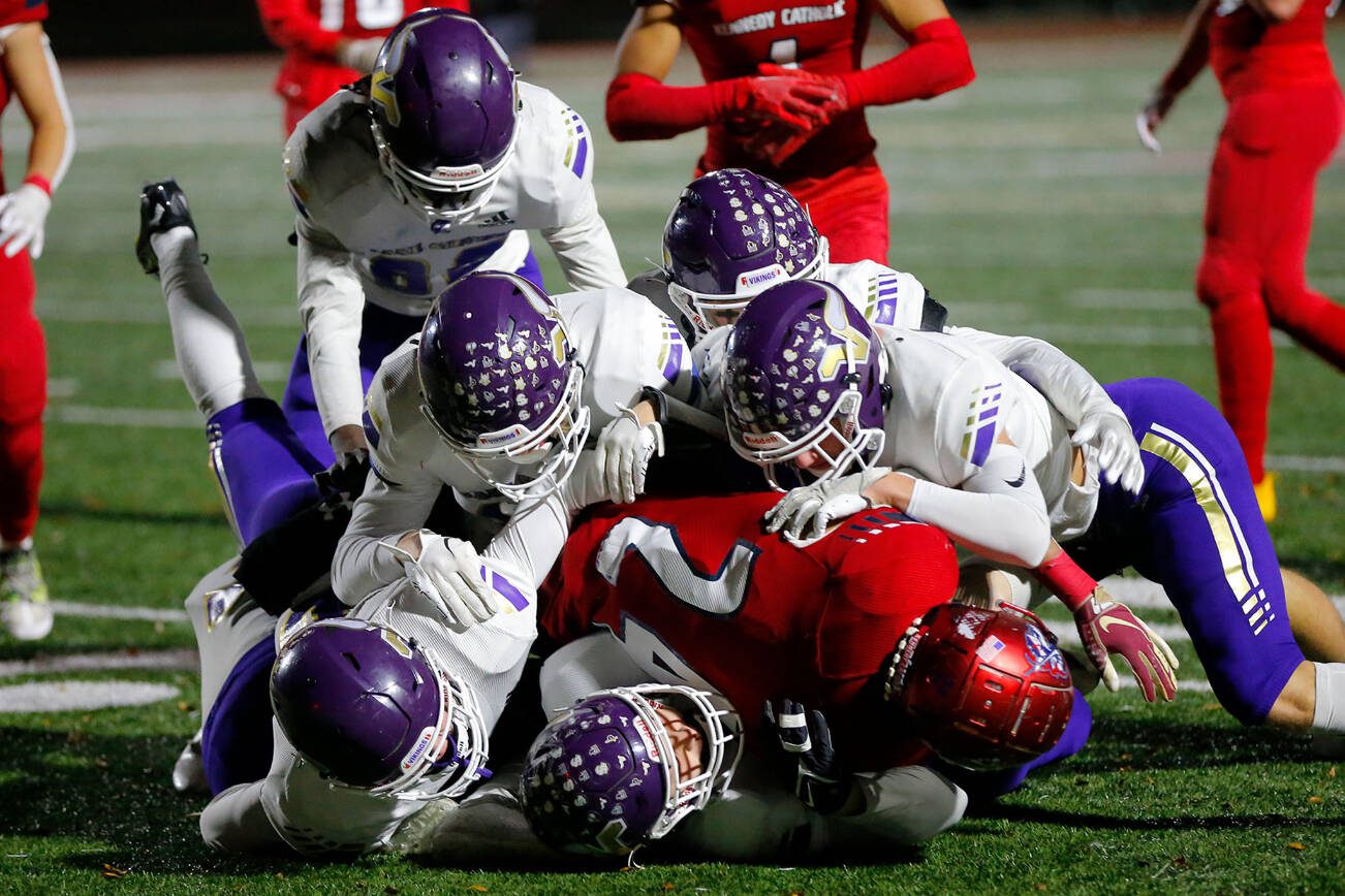 A gang of Lake Stevens defenders stop Xe'Ree Alexander against Kennedy Catholic in the WIAA 4A State Football Championship game Saturday, Dec. 3, 2022, at Mount Tahoma Stadium in Tacoma, Washington. (Ryan Berry / The Herald)