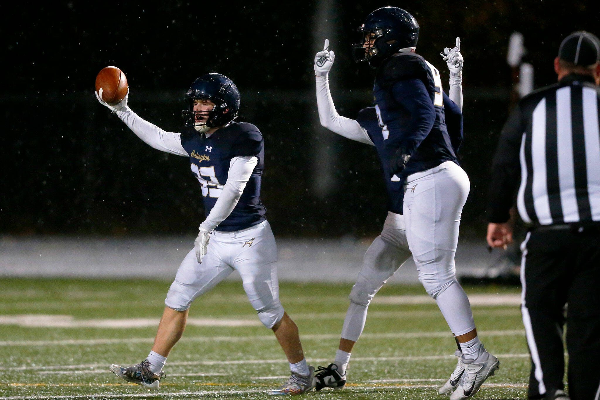 Arlington senior Bookie Cramer comes up with a fumble recovery against Ridgeline during a Class 3A state playoff matchup Nov. 10 in Arlington. (Ryan Berry / The Herald)