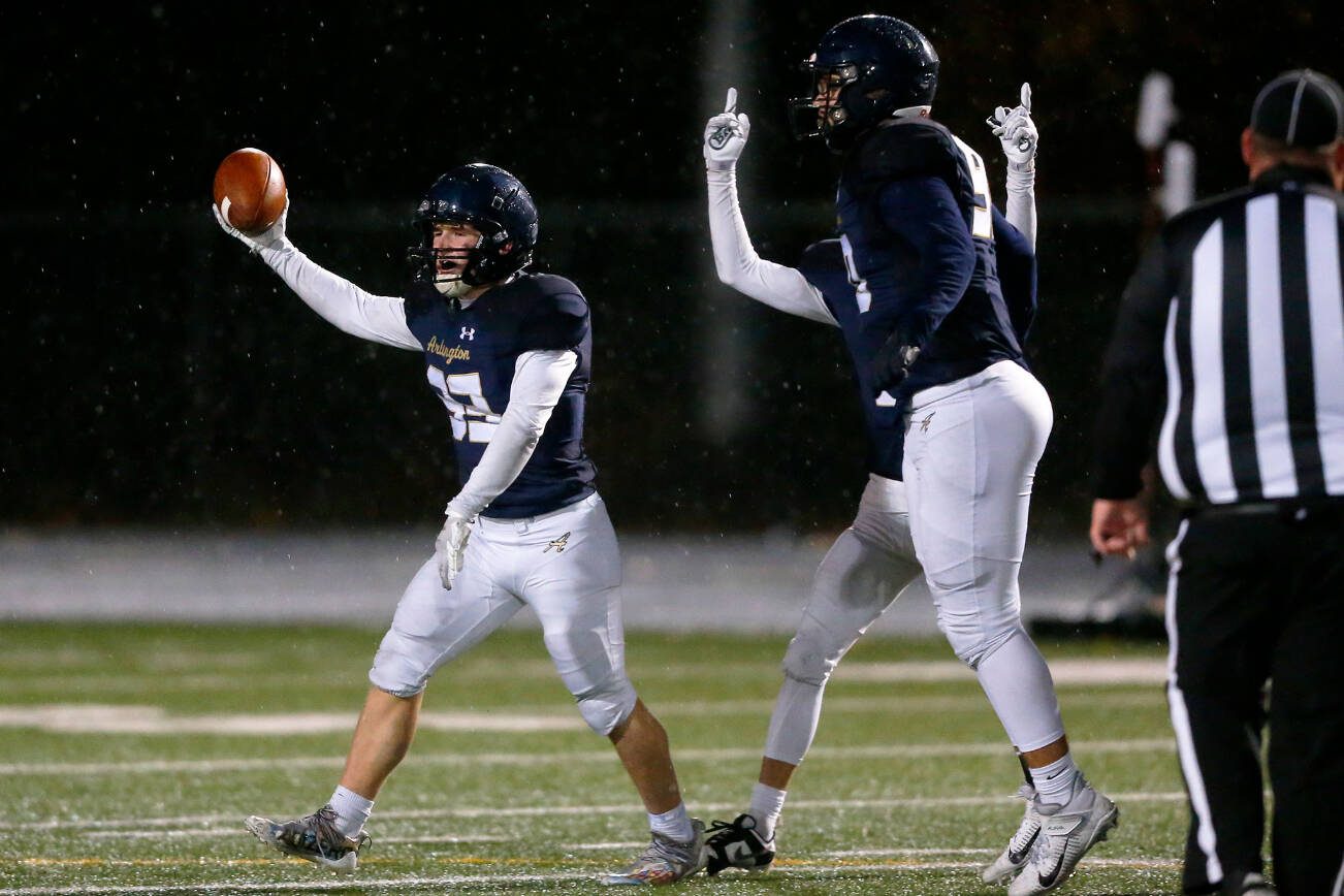 Arlington senior defender Bookie Cramer comes up with a fumble recovery against Ridgeline during a playoff matchup Friday, Nov. 10, 2023, at Arlington High School in Arlington, Washington. (Ryan Berry / The Herald)