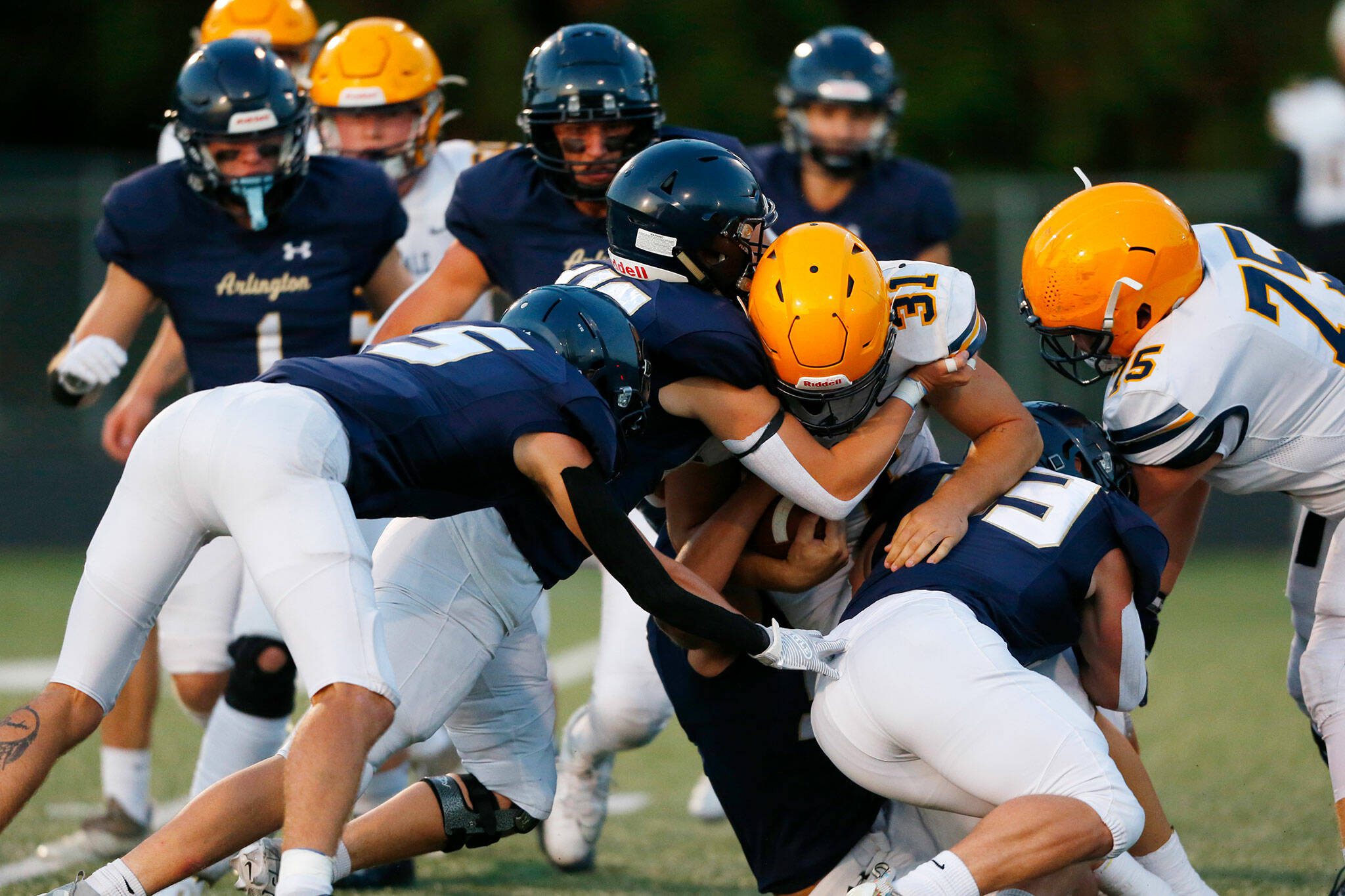 Arlington’s defense stuffs Ferndale running back Talan Bungard during a game Sept. 22 at John C. Larson Stadium in Arlington. (Ryan Berry / The Herald)