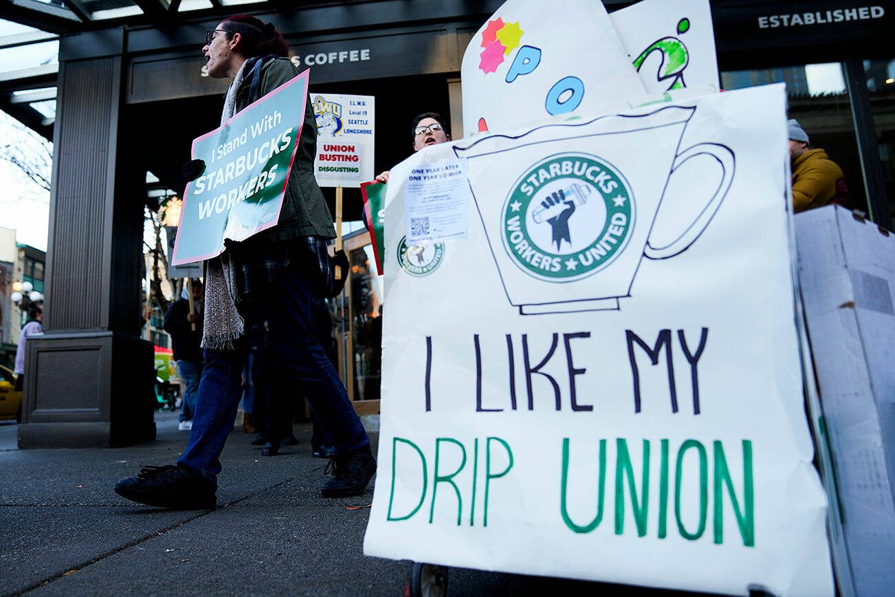 Starbucks workers and allies participate in a strike and picket organized by Starbucks Workers United during the company's Red Cup Day Thursday, Nov. 16, 2023, at a location near Pike Place Market in Seattle. (AP Photo/Lindsey Wasson)