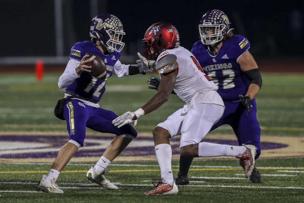 Lake Stevens’ Kolton Matson (12) moves with the ball during a game between Lake Stevens and Kennedy Catholic at Lake Stevens High School in Lake Stevens, Washington on Friday, Nov. 17, 2023. Lake Stevens won, 44-21. (Annie Barker / The Herald)
