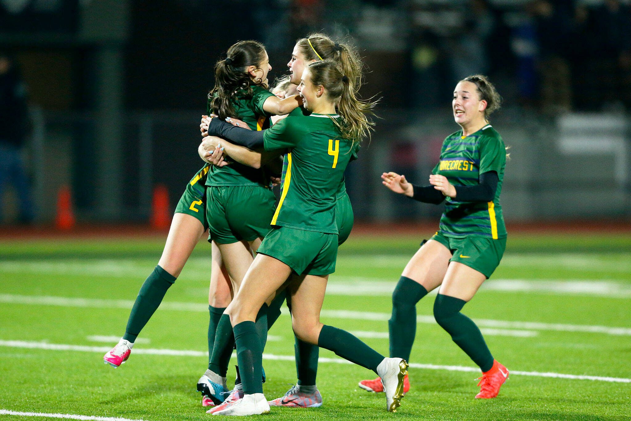 Shorecrest players begin to swarm junior defender Anica Boguszewki after she made the decisive penalty kick against Lakeside during a Class 3A state semifinal game Friday at Sparks Stadium in Puyallup. (Ryan Berry / The Herald)