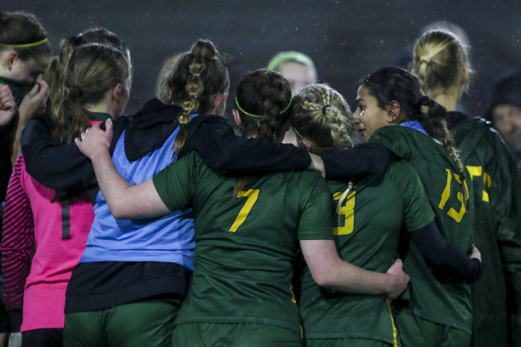 Shorecrest players huddle after the Class 3A girls soccer state championship game against Roosevelt on Saturday at Sparks Stadium in Puyallup. (Annie Barker / The Herald)

