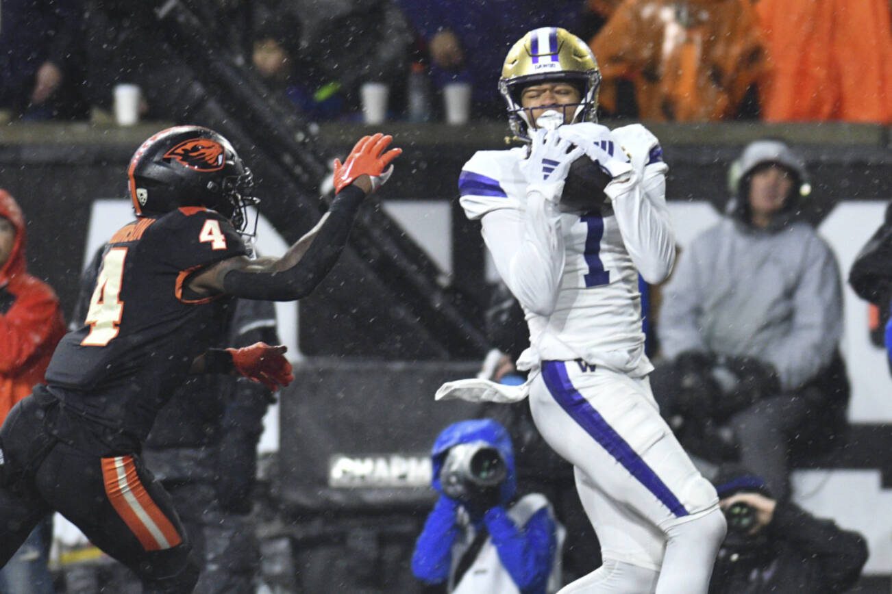 Washington wide receiver Rome Odunze (1) catches a pass for a touchdown as Oregon State defensive back Jaden Robinson (4) defends during the first half of an NCAA college football game Saturday, Nov. 18, 2023, in Corvallis, Ore. (AP Photo/Mark Ylen)