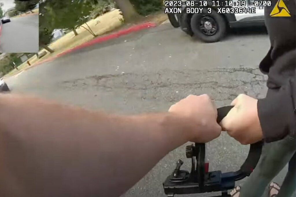 From the bodycam footage of Everett police officer Ryan Greely and footage from Molly Wright, officer Ryan Greely grabs the Wright’s camera as he arrests her on Aug. 10, 2023 in Everett, Washington. (Screenshot from a video provided by Molly Wright)
