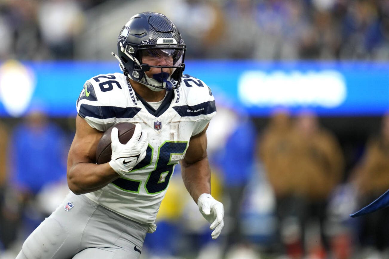 Seattle Seahawks running back Zach Charbonnet (26) runs the ball during the second half of an NFL football game against the Los Angeles Rams Sunday, Nov. 19, 2023, in Inglewood, Calif. (AP Photo/Ashley Landis)