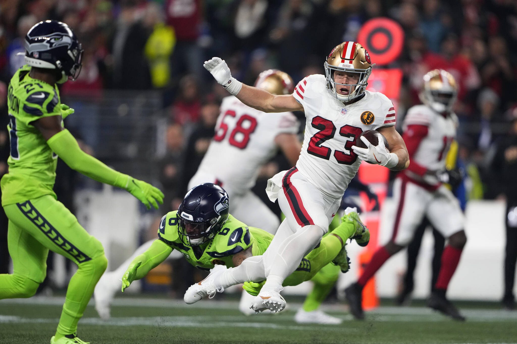 San Francisco 49ers running back Christian McCaffrey (23) pulls away from Seattle Seahawks safety Quandre Diggs (6) during the first half of Thursday’s game in Seattle. (AP Photo/Lindsey Wasson)