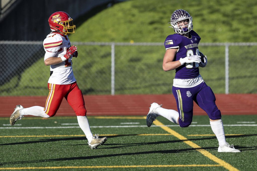 Lake Stevens’ Keagan Howard (80) scores during a Class 4A state semifinal game against Kamiakin on Saturday in Lake Stevens. (Annie Barker / The Herald)
