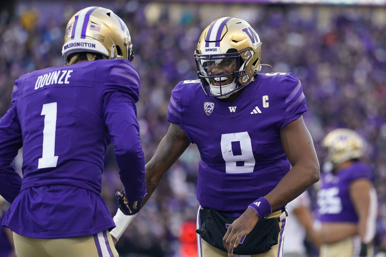 Washington quarterback Michael Penix Jr. (9) celebrates throwing a touchdown to wide receiver Rome Odunze (1) against Washington State during the first half of an NCAA college football game, Saturday, Nov. 25, 2023, in Seattle. (AP Photo/Lindsey Wasson)