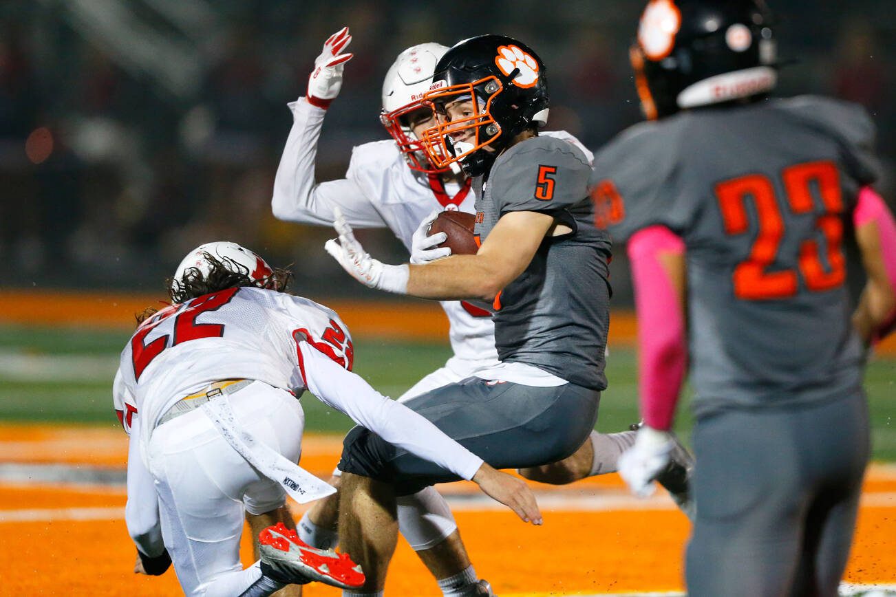 Granite Falls senior James Porter braces for a hit after making a catch against Kings on Friday, Oct. 19, 2023, at Granite Falls High School in Granite Falls, Washington. (Ryan Berry / The Herald)