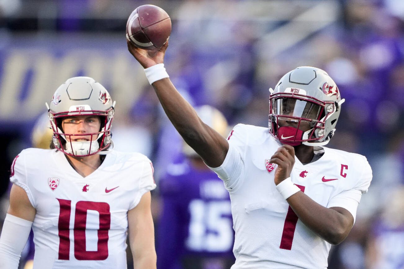 Washington State quarterback Cameron Ward (1) throws during warmups before an NCAA college football game against Washington, Saturday, Nov. 25, 2023, in Seattle. (AP Photo/Lindsey Wasson)